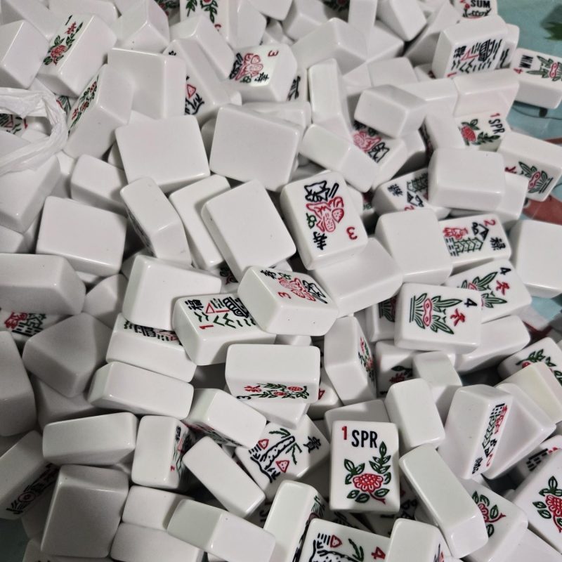A pile of white mah jongg tiles scattered and mixed