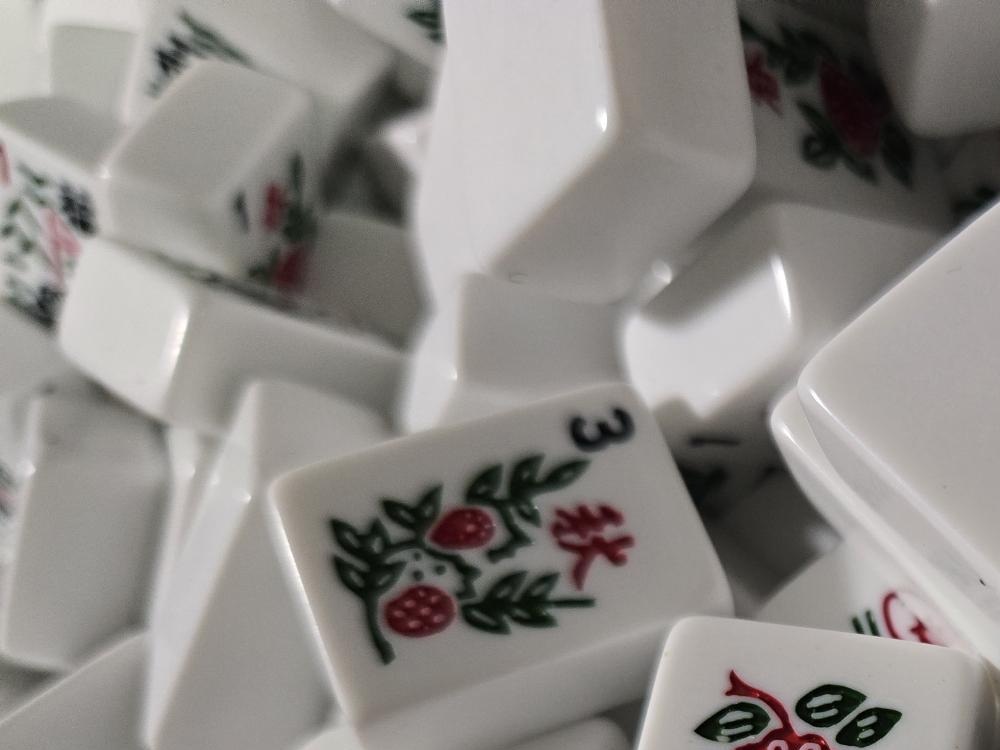 A pile of white mah jongg tiles scattered and mixed
